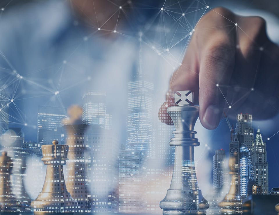 An image of a person playing chess with buildings faded in the background that is used for the MetaPerformance Strategy Consulting service.