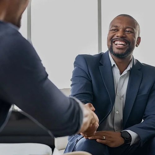 An image of a business man shaking another business man's hand which has been used on the MetaPerformance 'About Us' page.